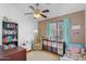 This bedroom has a bed, a chair, and plenty of space to play at 18811 N 34Th Ave # 6, Phoenix, AZ 85027