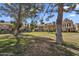 Attractive exteriors of the townhomes featuring traditional architecture and a well-maintained lawn with mature trees at 18811 N 34Th Ave # 6, Phoenix, AZ 85027
