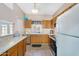 Efficient kitchen with tile flooring, wood cabinets, stainless steel dishwasher, and lots of counter space at 18811 N 34Th Ave # 6, Phoenix, AZ 85027