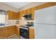 Functional kitchen with wood cabinets, stainless steel appliances, tile flooring, and lots of workspace at 18811 N 34Th Ave # 6, Phoenix, AZ 85027