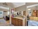 A kitchen with cabinets and counter overlooks the living and dining area at 18811 N 34Th Ave # 6, Phoenix, AZ 85027