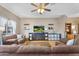 Well-lit living room featuring hardwood floors, contemporary entertainment center, and a spacious seating area at 18811 N 34Th Ave # 6, Phoenix, AZ 85027