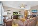 Spacious living room with hardwood floors, ceiling fan, comfortable seating, and entertainment center at 18811 N 34Th Ave # 6, Phoenix, AZ 85027