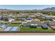 An aerial view of the property, showcasing its spacious layout, tennis courts, lush greenery, and neighborhood at 18826 E Augusta Ave, Queen Creek, AZ 85142