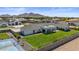 Expansive backyard with lush green lawn, sports court, and covered patio, set against a backdrop of scenic mountains at 18826 E Augusta Ave, Queen Creek, AZ 85142