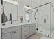 Modern bathroom with sleek double vanity and an elegant glass-enclosed shower at 18826 E Augusta Ave, Queen Creek, AZ 85142