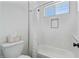 Bright and clean bathroom with a tub and white tiled walls at 18826 E Augusta Ave, Queen Creek, AZ 85142