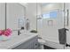 Bright bathroom featuring a gray vanity, white tile shower, and modern fixtures at 18826 E Augusta Ave, Queen Creek, AZ 85142