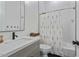 Charming bathroom featuring decorative floral shower curtain, white vanity and black hardware at 18826 E Augusta Ave, Queen Creek, AZ 85142