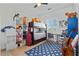 Cozy bedroom with bunk beds, a desk, and shelves filled with colorful items at 18826 E Augusta Ave, Queen Creek, AZ 85142