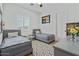 Cozy bedroom with two twin beds, neutral decor, and ample natural light, creating a serene space at 18826 E Augusta Ave, Queen Creek, AZ 85142