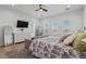 Bedroom with natural light from window, a ceiling fan, and a cozy seating area at 18826 E Augusta Ave, Queen Creek, AZ 85142