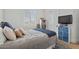 Cozy bedroom features a large window and a TV with blue storage beneath it at 18826 E Augusta Ave, Queen Creek, AZ 85142