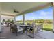 Spacious covered patio with a ceiling fan and comfortable seating arrangement, ideal for outdoor living at 18826 E Augusta Ave, Queen Creek, AZ 85142