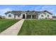 Inviting single Gathering home featuring dormer windows, stone accents, a manicured lawn, and walkway at 18826 E Augusta Ave, Queen Creek, AZ 85142