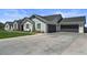 Well-maintained house shows off a three-car garage, lush green lawn, and beautiful landscape at 18826 E Augusta Ave, Queen Creek, AZ 85142