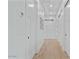 Bright hallway with hardwood floors, white walls, and white panel doors at 18826 E Augusta Ave, Queen Creek, AZ 85142
