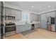 Modern kitchen with stainless steel appliances, gray cabinets, and hardwood floors at 18826 E Augusta Ave, Queen Creek, AZ 85142