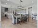 Dining area with views into the kitchen featuring gray cabinets and stainless appliances at 18826 E Augusta Ave, Queen Creek, AZ 85142