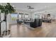 Bright living room featuring a ceiling fan and light wood floors at 18826 E Augusta Ave, Queen Creek, AZ 85142