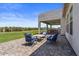 Comfortable outdoor patio with plush seating, perfect for relaxing or entertaining, with views of the green landscape at 18826 E Augusta Ave, Queen Creek, AZ 85142