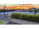 Outdoor pickleball and basketball court with dusk lighting and mature landscaping create a beautiful backyard paradise at 18826 E Augusta Ave, Queen Creek, AZ 85142