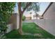 Private backyard features lush green lawn, mature tree, and block fence, offering a serene outdoor space at 19115 N 71St Dr, Glendale, AZ 85308