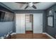 Comfortable bedroom with a closet, dark gray walls, wood floors, and a ceiling fan at 19115 N 71St Dr, Glendale, AZ 85308