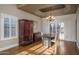 Elegant dining room featuring hardwood floors, a large table, and stylish chandelier at 19115 N 71St Dr, Glendale, AZ 85308