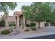 Charming desert landscaping surrounds this single-Gathering home, with well-manicured greenery, cacti, and flowering plants at 19115 N 71St Dr, Glendale, AZ 85308