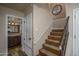 Hallway view with bathroom door on left and staircase on right at 19115 N 71St Dr, Glendale, AZ 85308