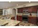 Updated kitchen featuring granite counters, stainless steel appliances, and tile backsplash at 19115 N 71St Dr, Glendale, AZ 85308