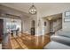 Open-concept living area with dining space, bar, and staircase at 19115 N 71St Dr, Glendale, AZ 85308