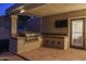 A great outdoor kitchen features a built-in grill, tiled countertops, and lots of space to cook and serve meals at 19115 N 71St Dr, Glendale, AZ 85308