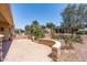 Landscaped backyard featuring a stone wall, desert plants, and a scenic view at 19225 N Tallowood Way, Surprise, AZ 85387