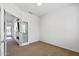 Bedroom showing neutral carpet, white walls, and glass door with a view to the outside at 19225 N Tallowood Way, Surprise, AZ 85387