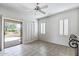 Sunlit bedroom with a sliding glass door leading to a private patio at 19225 N Tallowood Way, Surprise, AZ 85387