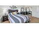 Bedroom with stylish linens, bedside tables, dark furniture, and a mirrored closet at 19225 N Tallowood Way, Surprise, AZ 85387
