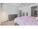 Relaxing bedroom with neutral walls and carpet, and a cozy pink comforter on the bed at 19225 N Tallowood Way, Surprise, AZ 85387