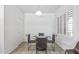Bright breakfast nook features a round table, four chairs, and shuttered windows at 19225 N Tallowood Way, Surprise, AZ 85387