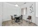 Bright breakfast nook features a round table, four chairs, and shuttered windows at 19225 N Tallowood Way, Surprise, AZ 85387