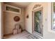 Covered porch area featuring a decorated front door and decorative accents at 19225 N Tallowood Way, Surprise, AZ 85387