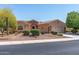 Single-story home featuring desert landscaping, stone accents, and a two-car garage at 19225 N Tallowood Way, Surprise, AZ 85387