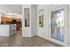 Bright foyer with glass accent window and tile flooring, and a view to the kitchen at 19225 N Tallowood Way, Surprise, AZ 85387
