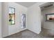 Bright foyer with glass accent window, tile flooring and view of kitchen at 19225 N Tallowood Way, Surprise, AZ 85387