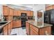 Well-equipped kitchen boasts granite counters and modern appliances at 19225 N Tallowood Way, Surprise, AZ 85387