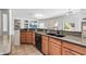 Spacious kitchen featuring granite counters, an island, and tile floors at 19225 N Tallowood Way, Surprise, AZ 85387