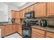 Well-equipped kitchen boasts granite counters and modern appliances at 19225 N Tallowood Way, Surprise, AZ 85387