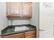 Functional laundry room with sink, faucet, overhead cabinets, and a convenient door at 19225 N Tallowood Way, Surprise, AZ 85387