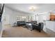 Bright living room with large windows, modern furniture and a ceiling fan at 19225 N Tallowood Way, Surprise, AZ 85387